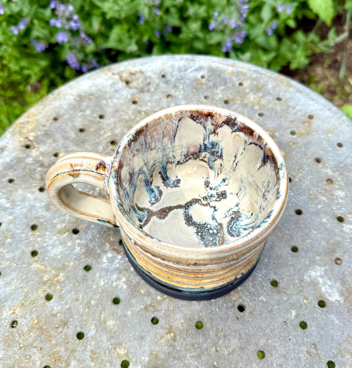 Close-up detail of layered ceramic glazes resembling topographic map lines
