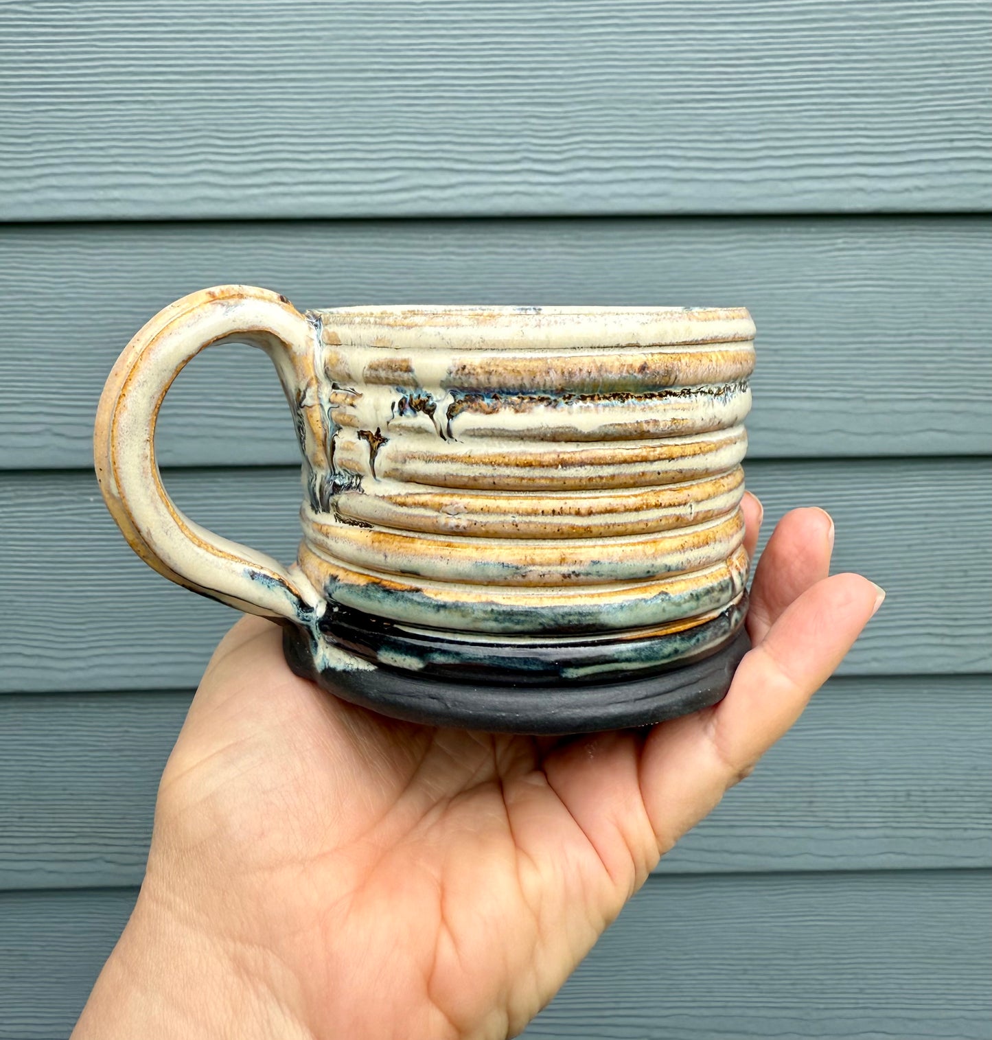 Side view of hand made ceramic ridged mug