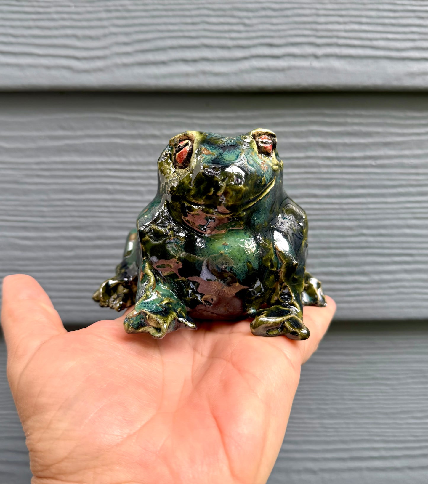 Mr. Frog ceramic figurine scale reference with hand or garden setting