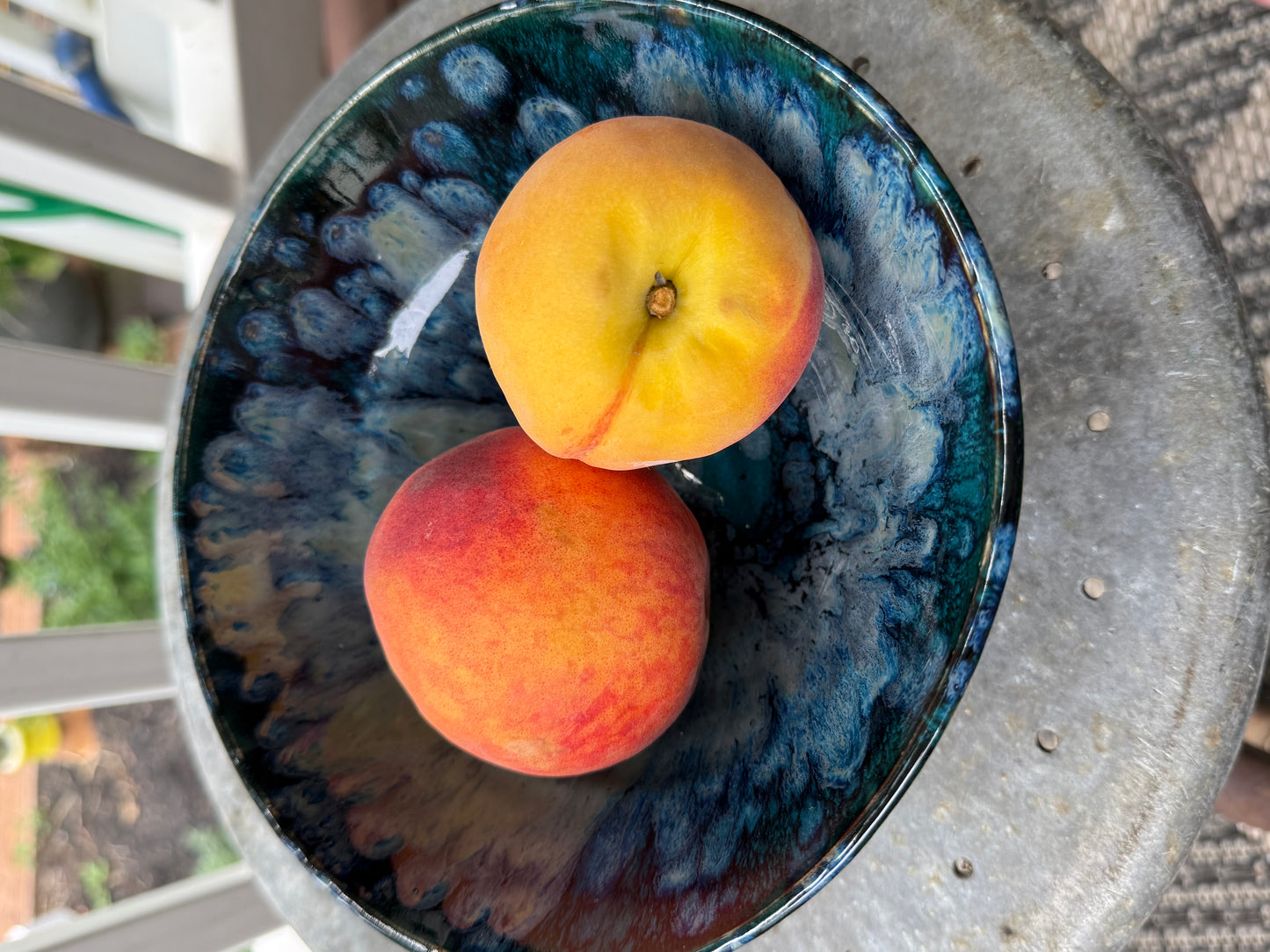 Close-up detail of handmade ceramic bowl showing textured glaze movement
