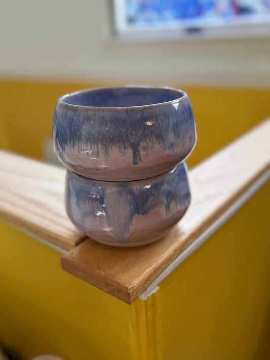 Set of two handmade ceramic bowls with flowing pink and blue glazes