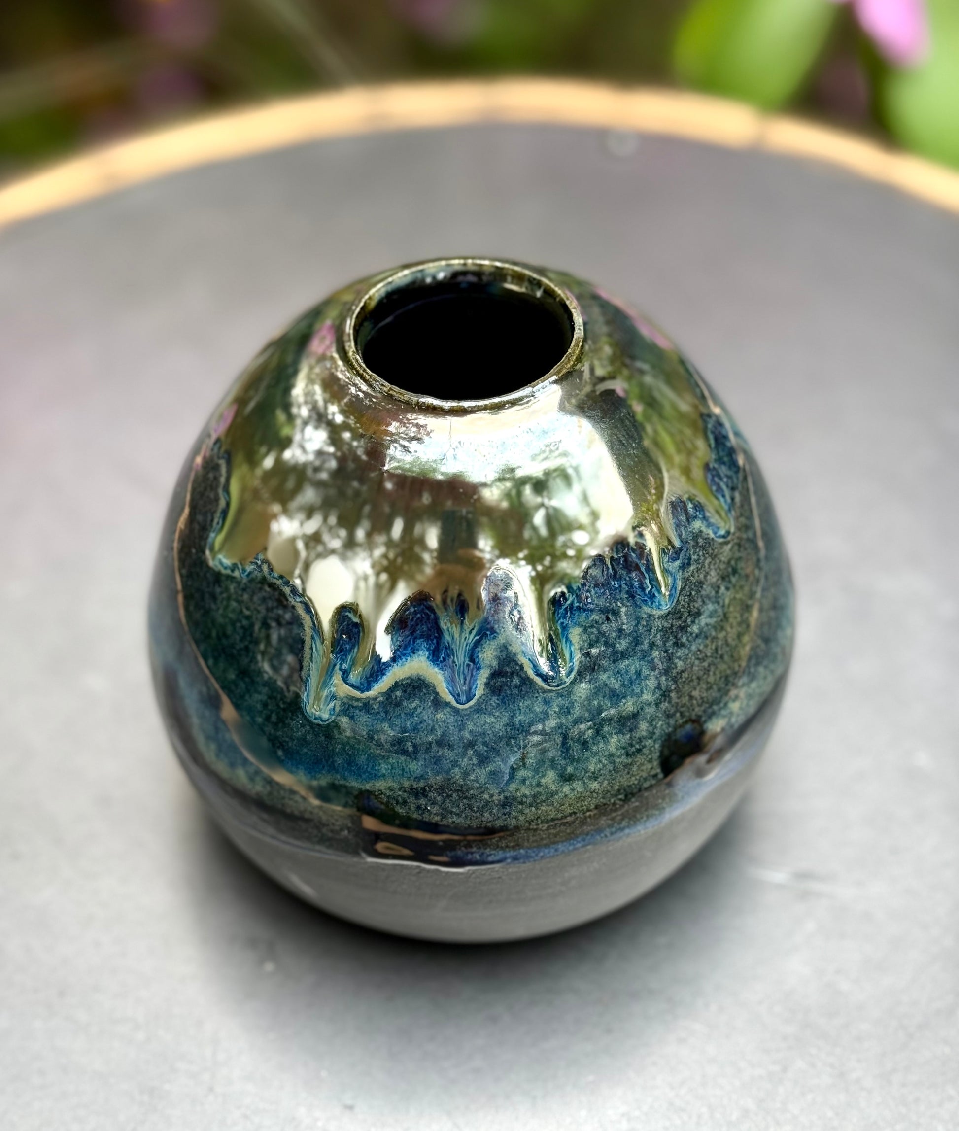 Close-up detail of sea-colored ceramic glaze with metallic sheen