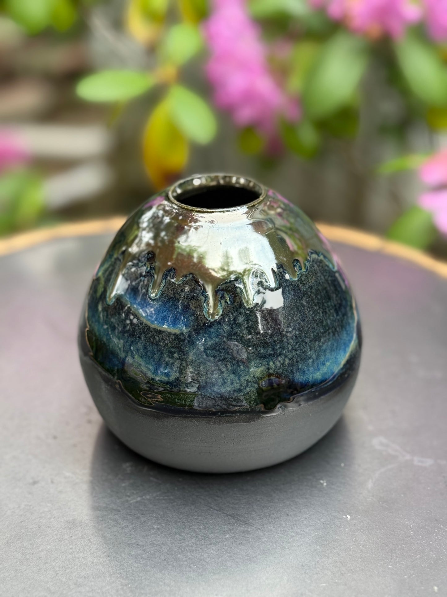 Ceramic vase profile showing elegant curved silhouette and glaze drips